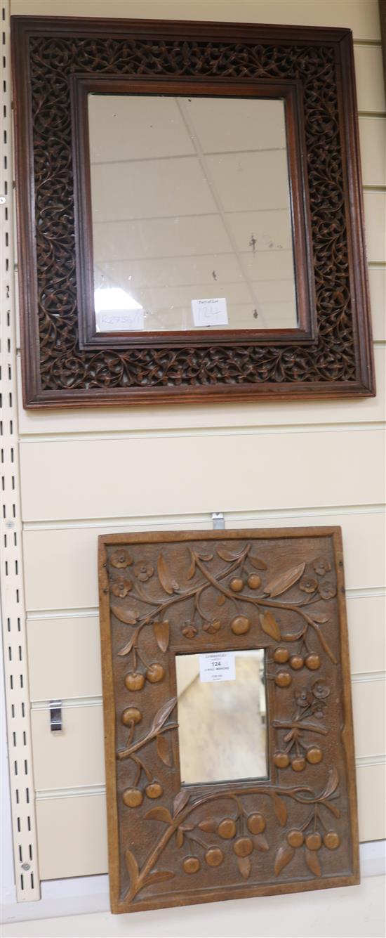 Two decoratively carved wooden wall mirrors